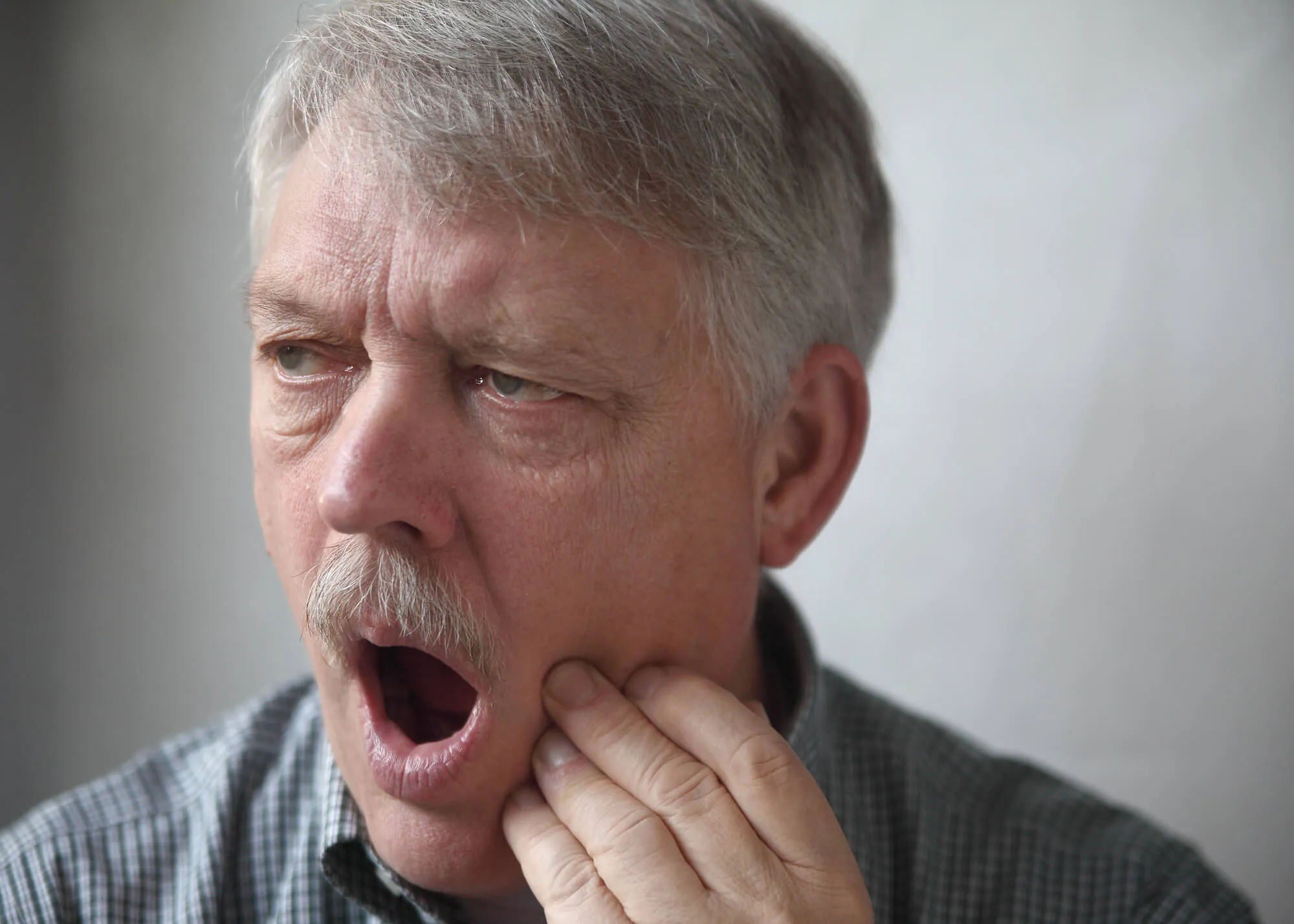 man with pain before going to dentist for tooth extraction